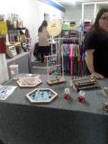 Photo of vendor table displaying miscellaneous custom jewelry for sale.