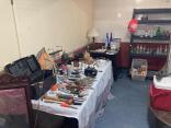 Photo of vendor table displaying miscellaneous tools and collectables for sale.