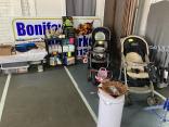 Photo of vendor table displaying miscellaneous baby items and collectables for sale.