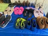 Photo of vendor table displaying miscellaneous shoes for sale.