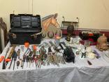 Photo of vendor table displaying miscellaneous tools and collectables for sale.