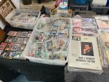 Photo of vendor table displaying miscellaneous trading cards, vintage items and collectable items for sale.